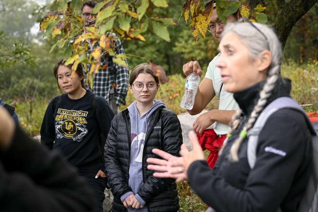 An educator at a state park shares information with a group of students