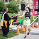 A finisher receives a (mock) diploma. Participants chose either the 5.07-mile Doctoral Derby or the 1.94-mile Master’s Mile. Race distances were based on the approximate average time to degree (in years) at UW–Madison.