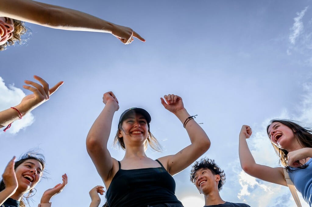 New students enthusiastically cheer each other on.