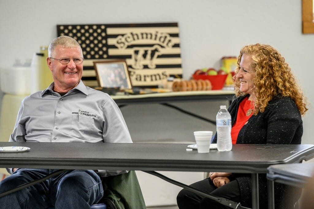 Chancellor Jennifer Mnookin (right) laughs with State Sen. Howard Marklein as they tour the Schmidt Dairy Farm in Lone Rock, Wis.