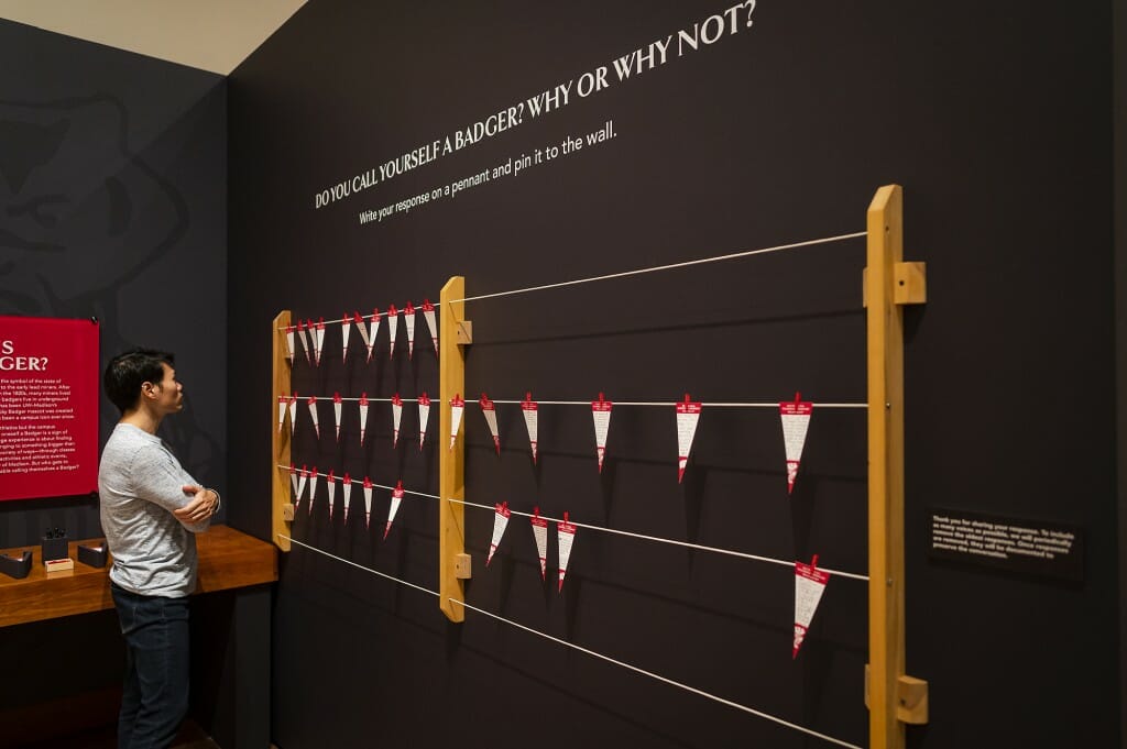 A man stands at an exhibit titled 