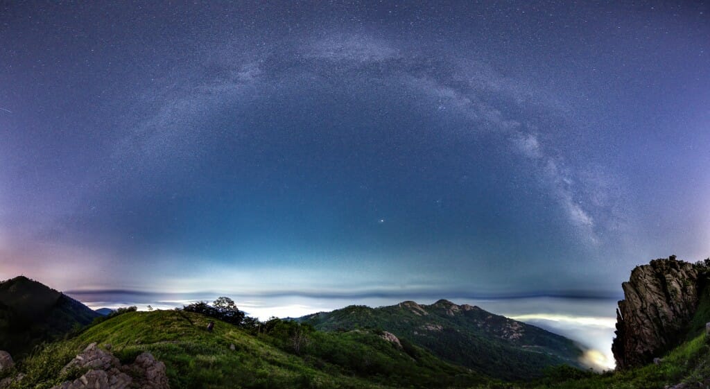 While it is difficult to see the stars of the Milky Way anywhere near the lights of a city, the galactic display in this assemblage of images taken above the Qingdao, China, area (population 7 million) is visible thanks to the blanket of fog dampening Qingdao’s light pollution.
Yingshun Sun,
graduate student, Atmospheric and Oceanic Sciences
digital camera