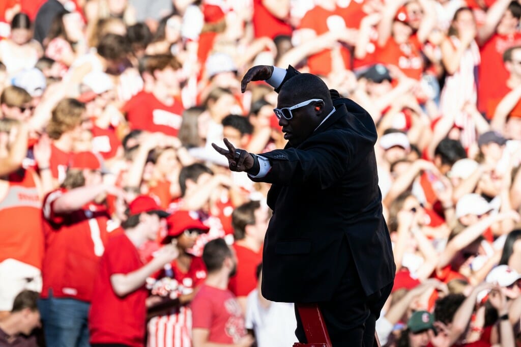 UW Marching Band director Corey Pompey leads the band’s halftime performance.