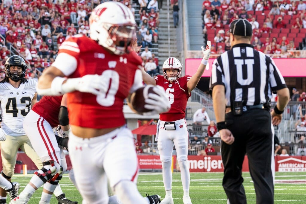 Wisconsin quarterback Graham Mertz (5) celebrates as running back Braelon Allen (0) runs the ball into the end zone for a touchdown.