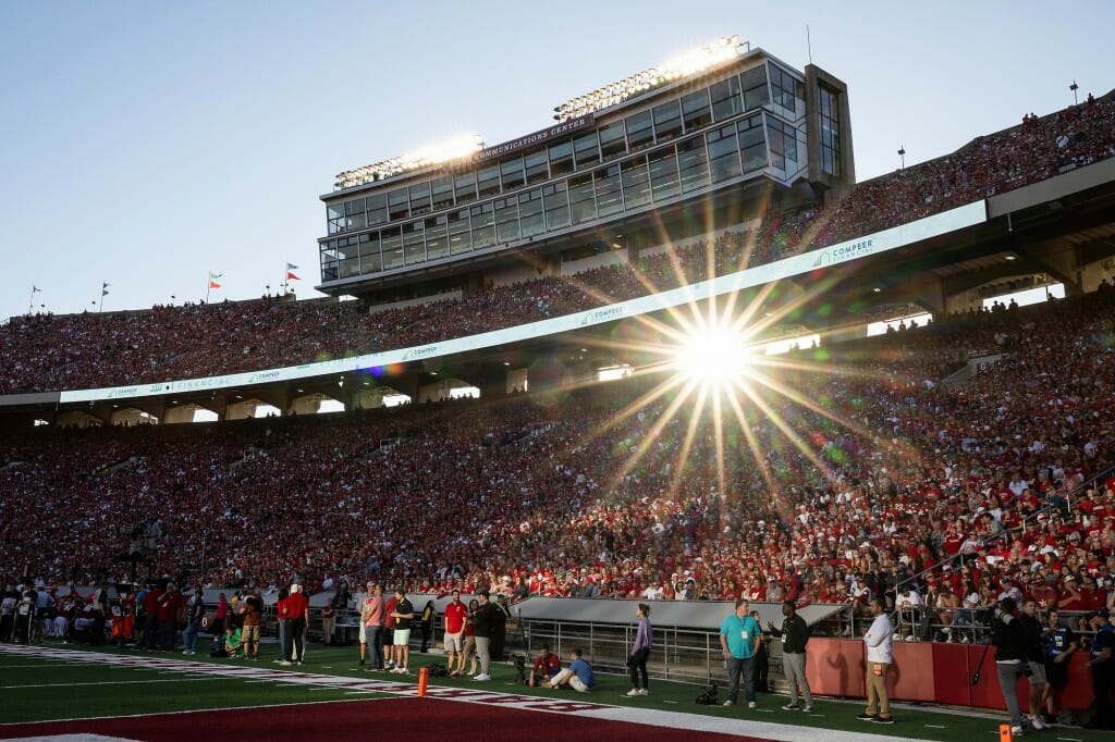 Lake afternoon sun shines through the upper deck as Badger fans cheer.