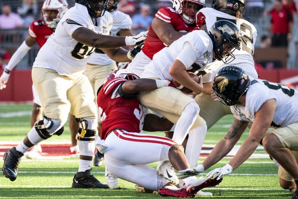 Wisconsin inside linebacker Jake Chaney (36) takes down Purdue quarterback Aidan O’Connell for the sack.