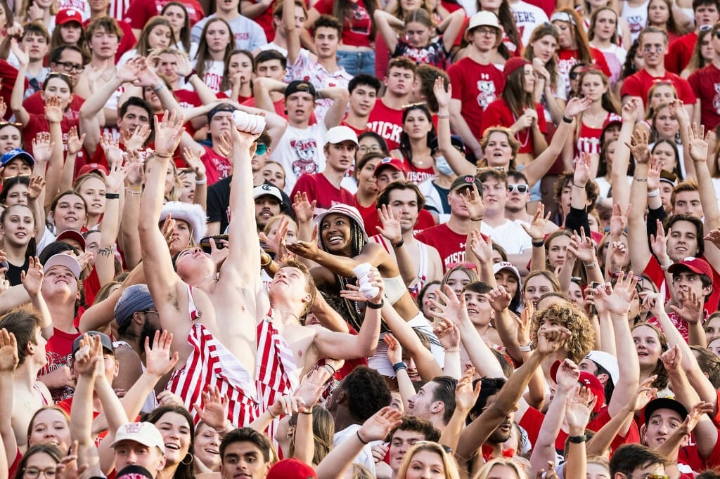 Fans cheer at a football game.