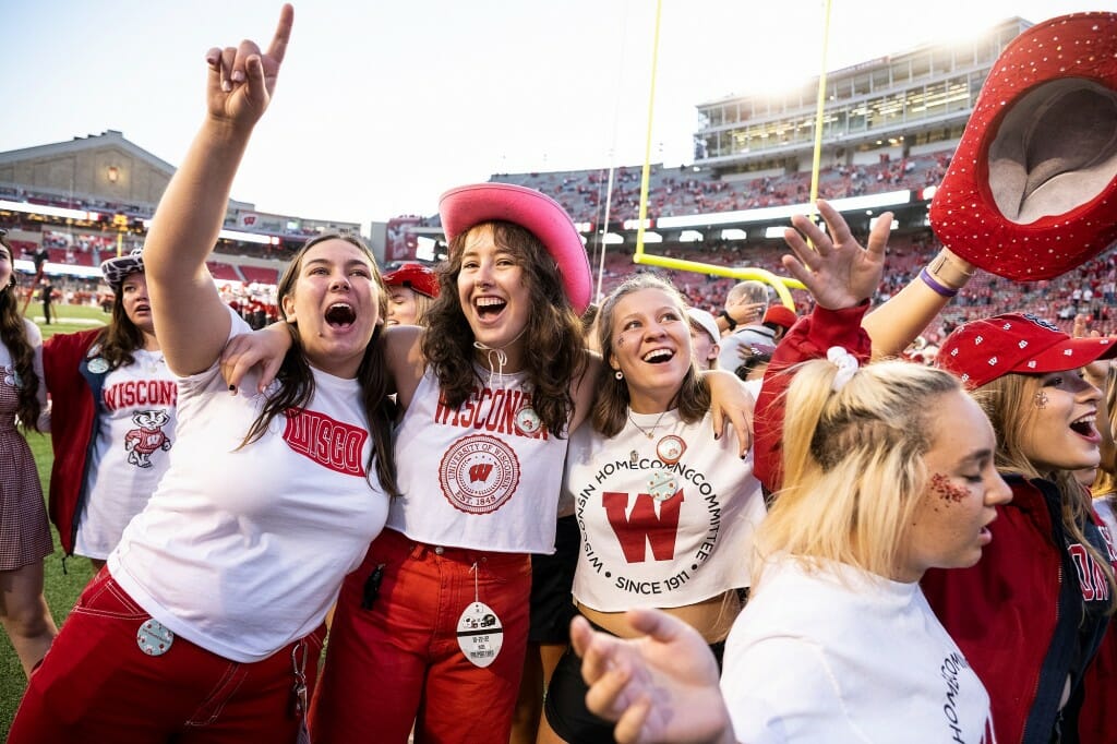 From left to right, UW Homecoming Committee members Kate Meyer, Ella Martinez and Paige Dessiart celebrate during the Fifth Quarter.