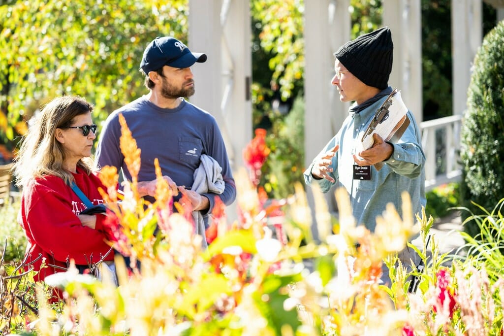 At right, garden staff Ryan Dostac describes Afro-Diasphoric garden features to Andrew Maule (center), a UW-Madison graduate student in horticulture, and Maule’s mother-in-law, Marie Pucker, during the Harvest Folk Festival.