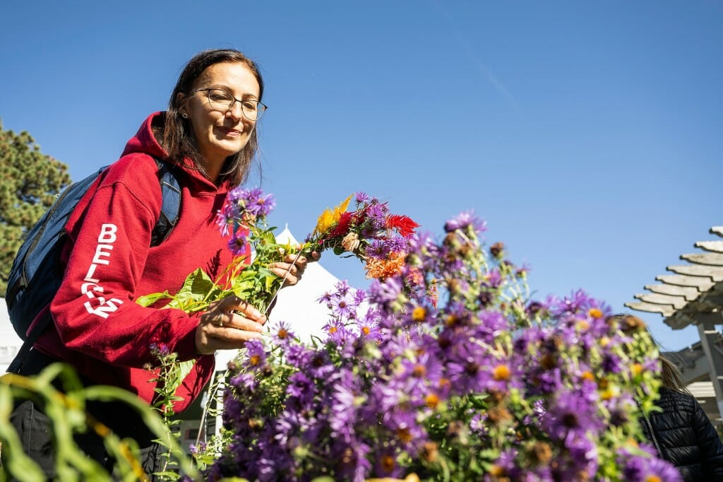 Brigitta Koncz, a Fulbright exchange teacher from Romania who is a visiting scholar in the School of Education at UW-Madison, creates wreaths from freshly cut stems and aster flowers.