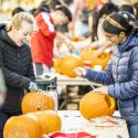 Students Sophia Schaubel (left) and Khadijah Dhoondia (right) delight in their pumpkin artistry.