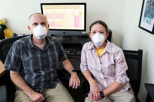 David O'Connor (left) and Shelby O'Connor sit in front of a computer screen showing a spreadsheet of data.