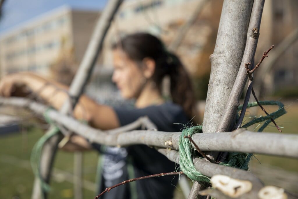 Blackdeer ties a knot in the construction of the ciiporoke. The structure, 17 feet by 32 feet and made of maple poles covered in canvas, went up in about six hours.