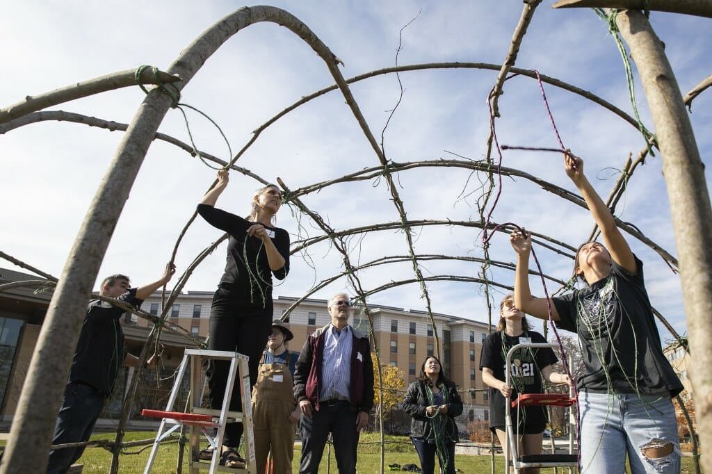 Volunteers building the ciiporoke, from left, include Blackdeer, Tom Dubois, Emily Smith, Woldt, Brian McInnes, Phoua Holt and Professor Marianne Fairbanks. Smith, a senior microbiology major, learned about the volunteer opportunity in her landscape architecture class. “I’ve never done anything like this, other than build a fort as a kid,” said Smith, of Spring Grove, Illinois. “It seemed like a cool opportunity to do something by hand instead of just read about it. And I hope it’s a reminder to students of where this land came from.”