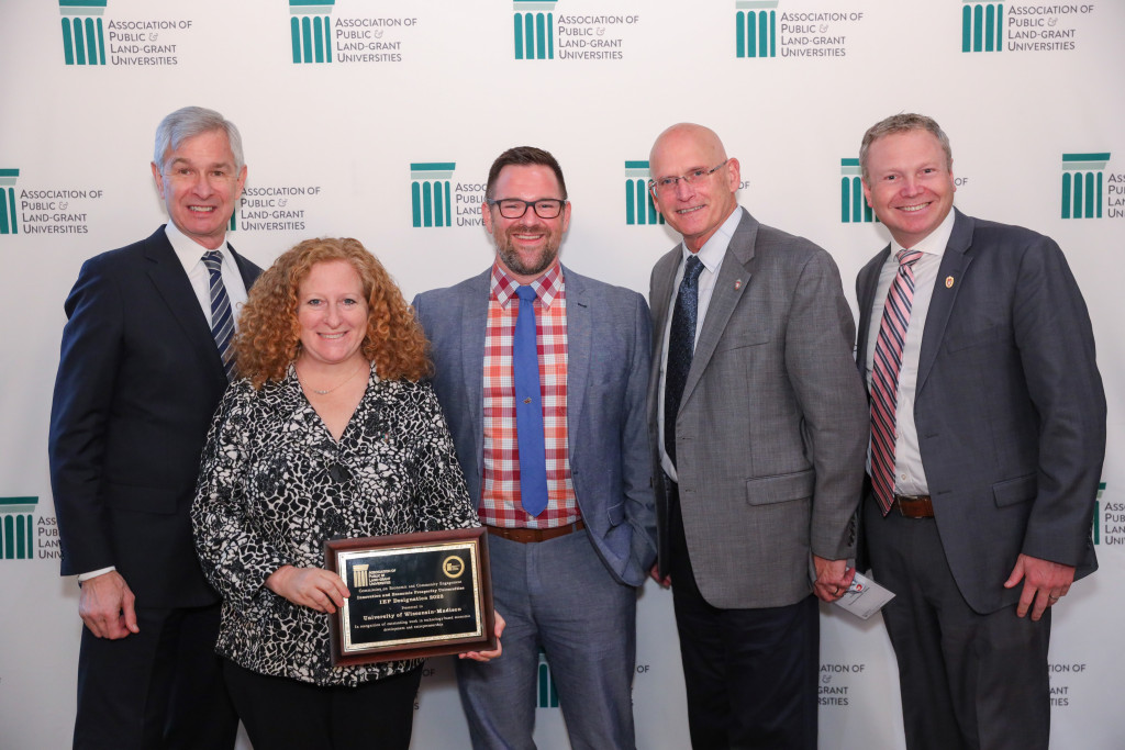 Chancellor Mnookin poses with a group holding the IEP award