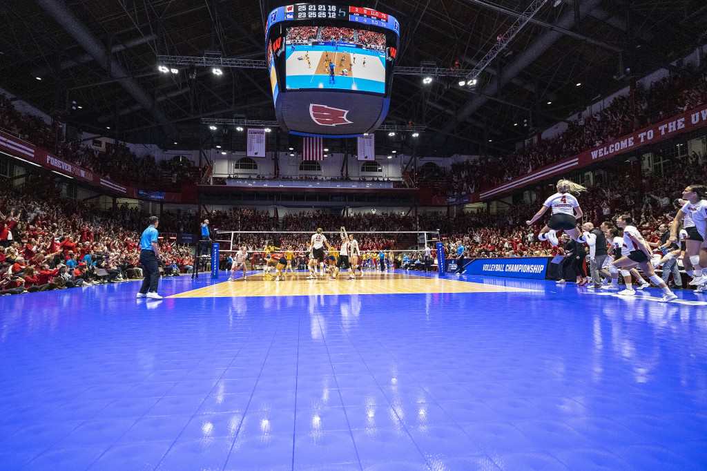 The Badgers celebrate after scoring a point in the fourth set on Saturday.