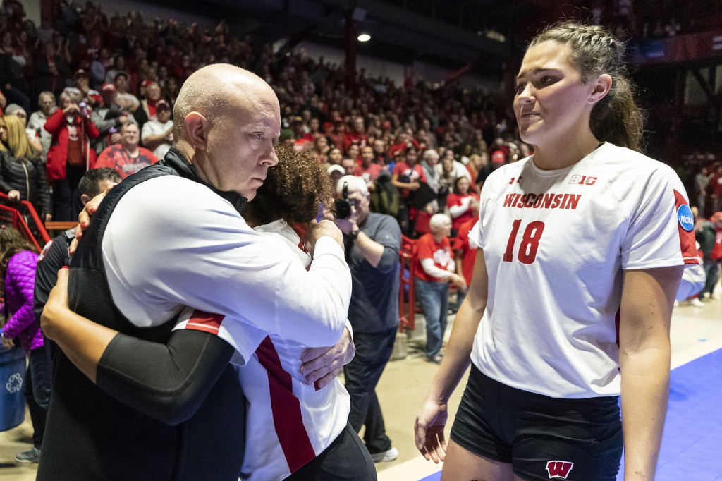 Head coach Kelly Sheffield (left) hugs senior players Shanel Bramschreiber (#5) and Danielle Hart (#18) after the loss to Pitt.