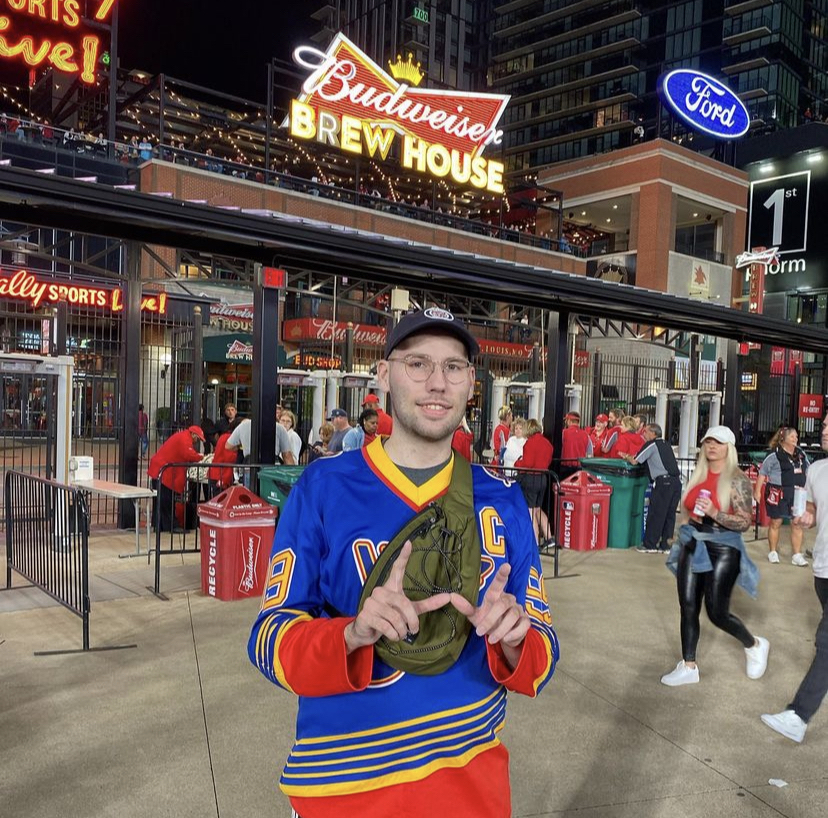 A man in a blue jersey saves the W at a baseball stadium.