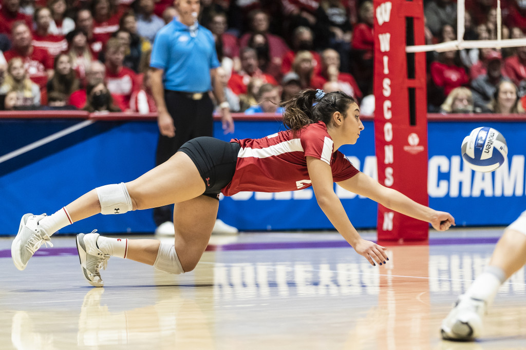 A player dives to hit the ball.