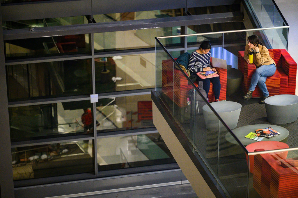 Two people look at books.