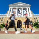 Students rush past Bascom Hall.