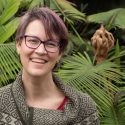 Portrait of Katherine McCulloh standing ini front of tropical plants in an indoor setting