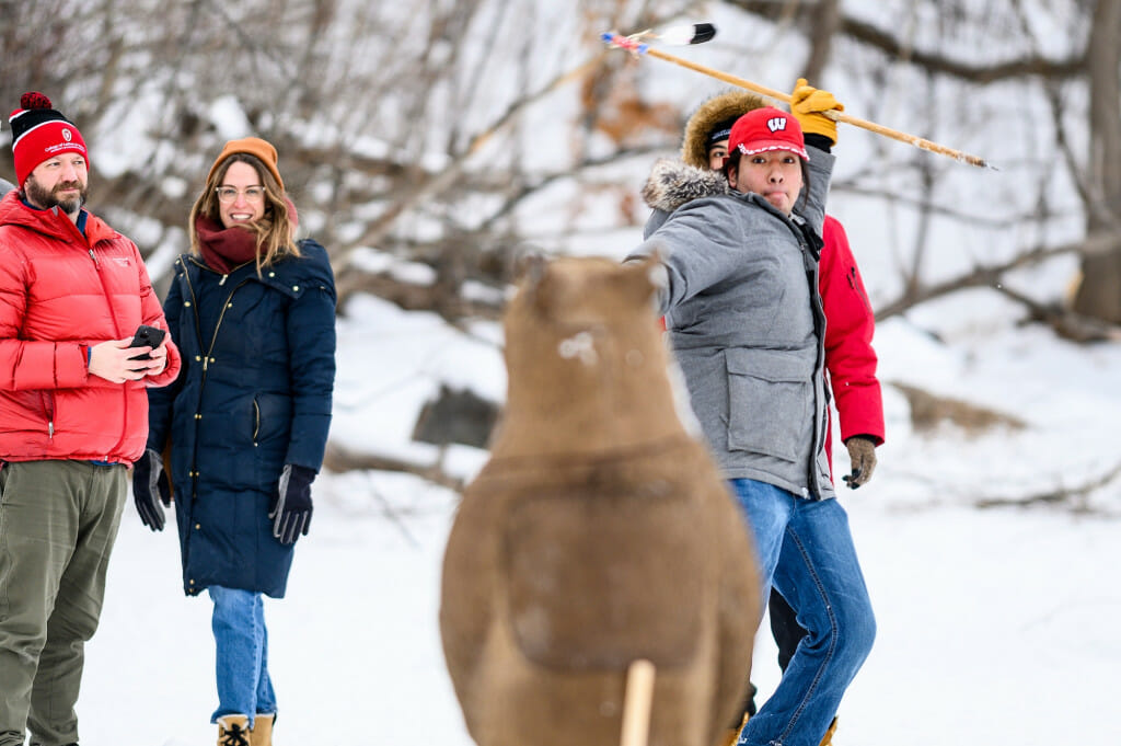 Silas Cleveland, a Ho-Chunk Nation member and UW student, prepares to throw a lance at a bear-shaped target at Ojibweg Bibooni-Ataadiiwin.