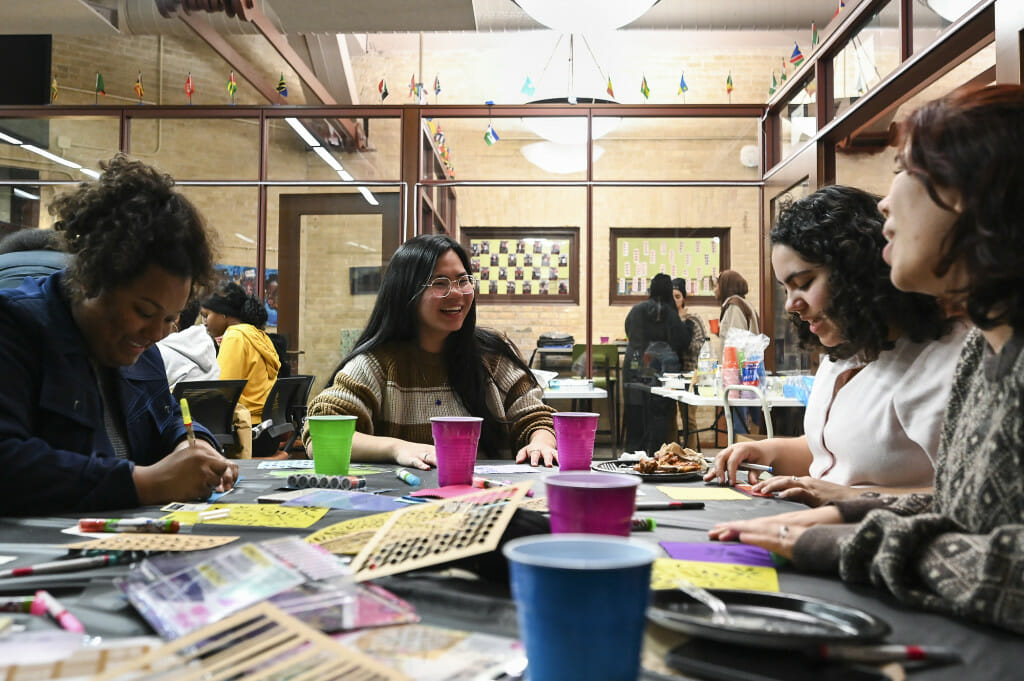 From left to right, Jasmine Jones, Mei Hippe, Sophia Whitehead, and Jasmine Lutz decorate textiles with markers.