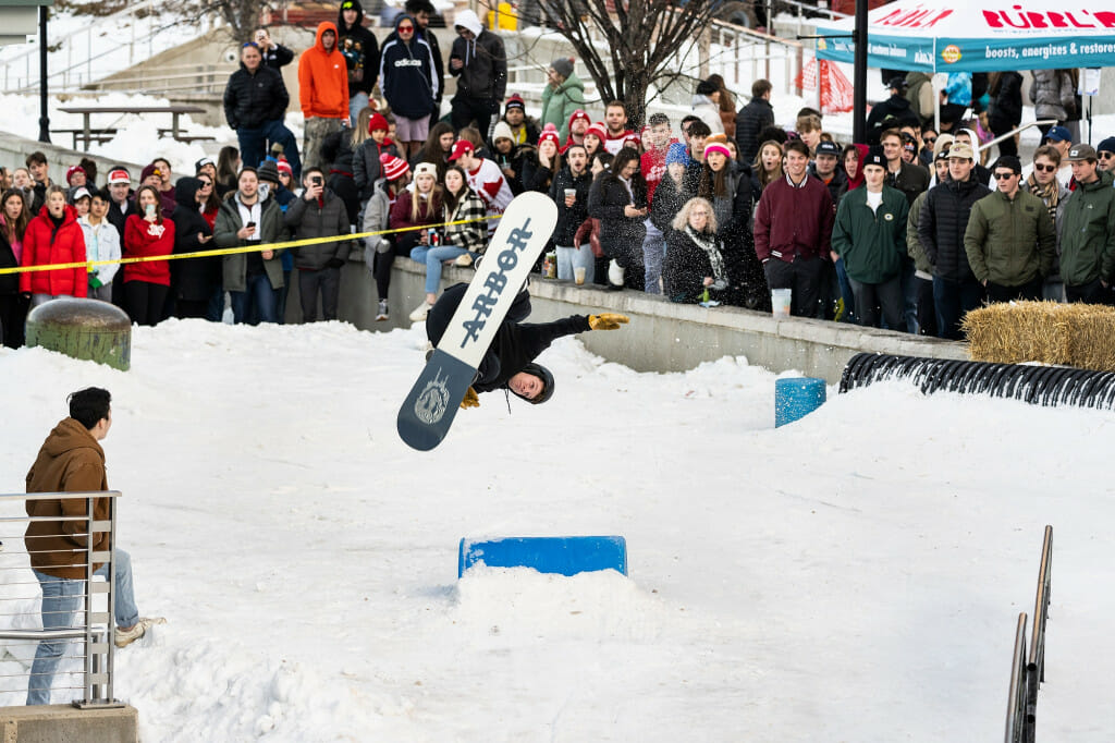 UW–Madison junior Ben Schultz completes a wildcat backflip as freestyle skiers and snowboarders compete in the Rail Jam at the snow-covered Memorial Union Terrace during Winter Carnival.