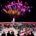 Hundreds of people watch as fireworks light up the night sky above an inflatable replica of the Statue of Liberty’s head, arm and torch on Lake Mendota.