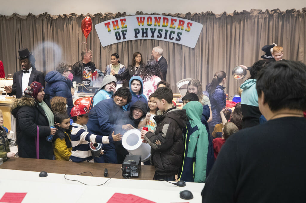 Children shoot rings of air out of a vortex cannon after the show.