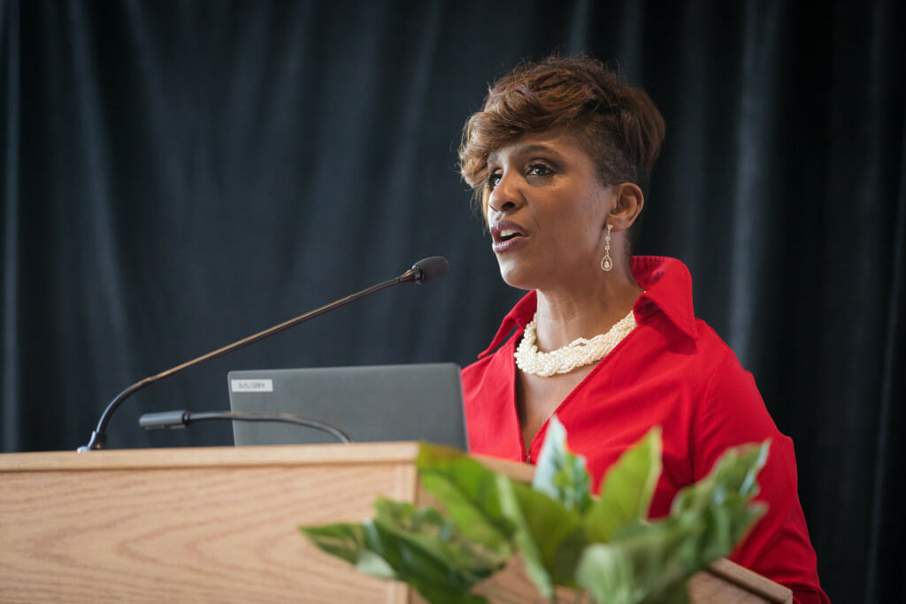 Angela Byars-Winston speaks from a podium.