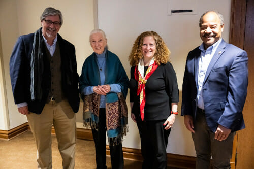 Four people pose for a photograph.