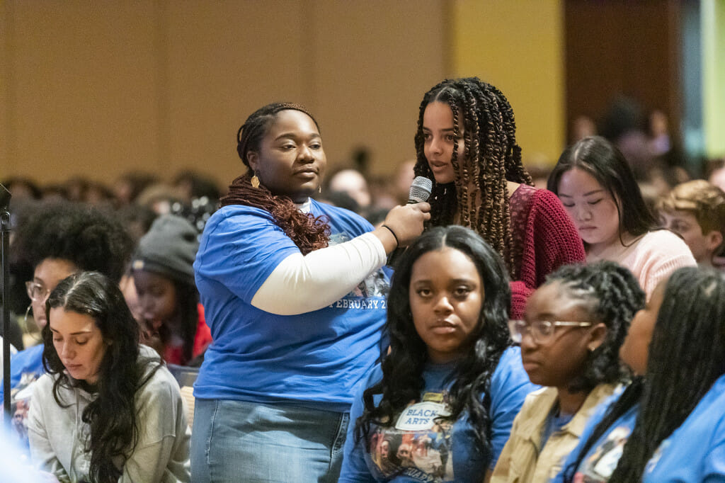 Black History Month Committee member Lisa Amanor (left) assists an audience member in asking a question.