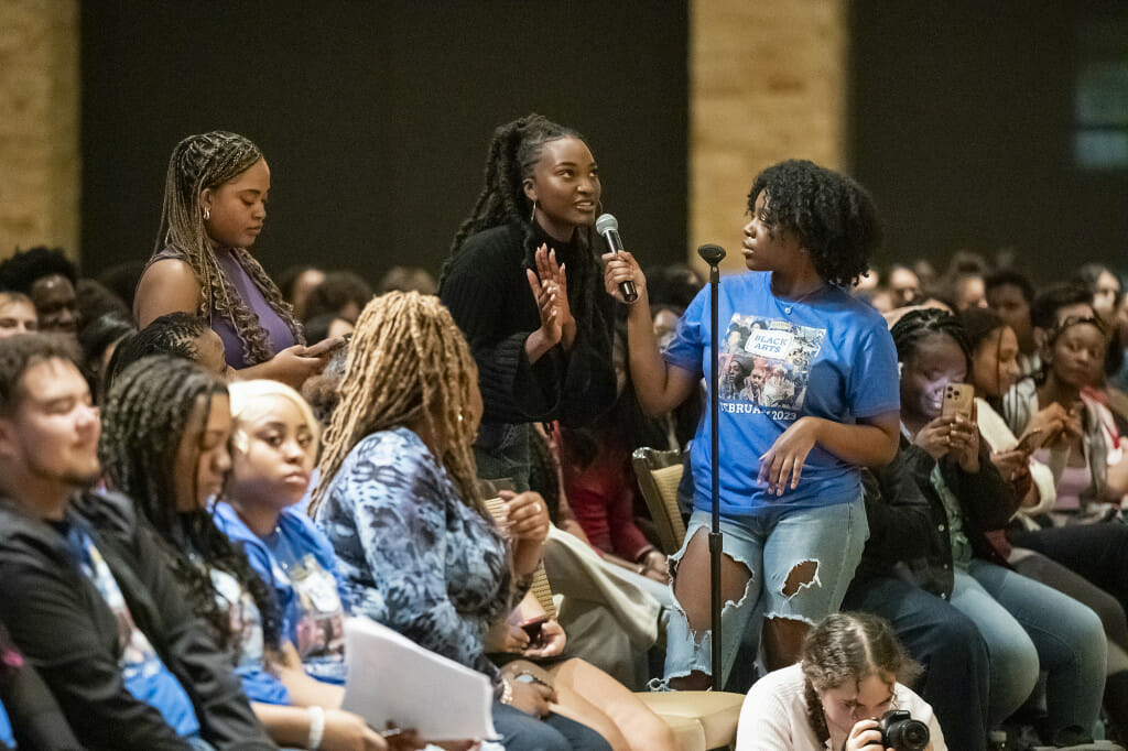 Black History Month Committee member Tchoumba Paasewe(right) assists undergraduate student Joya Headly in asking a question.