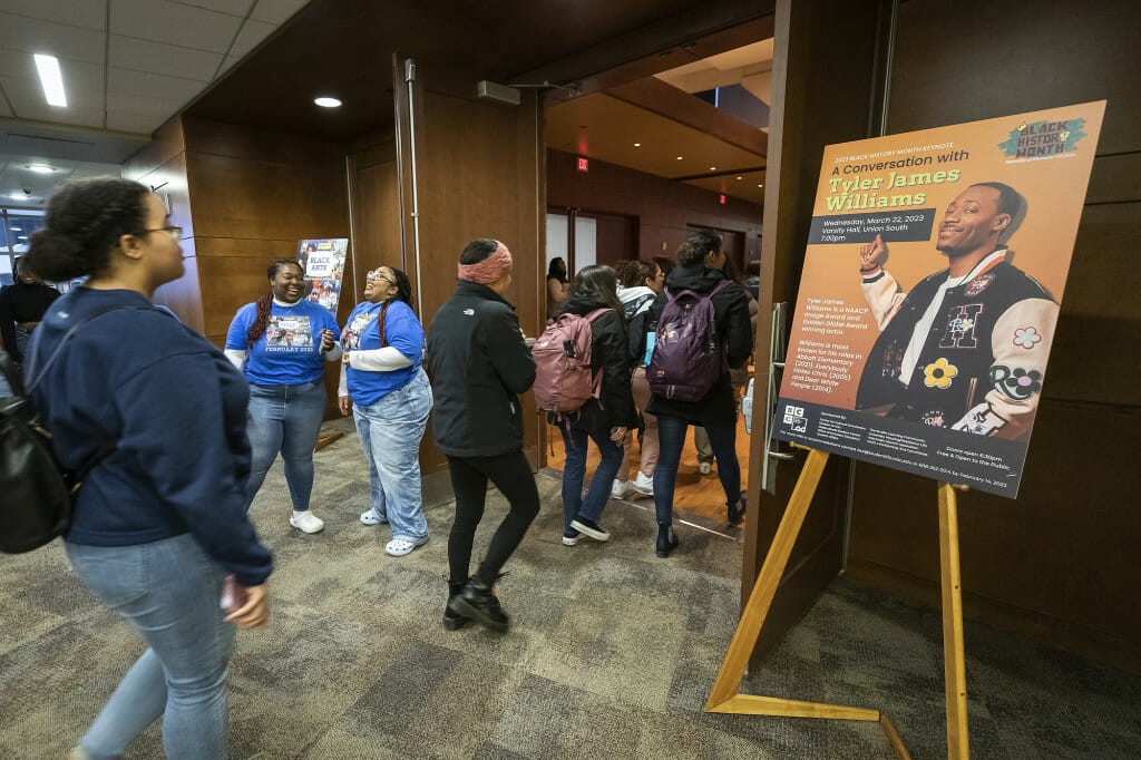 Black History Month Planning Committee members Lisa Amanor (left) and Serenity Givens-Sheets (right) greet people arriving for the event.