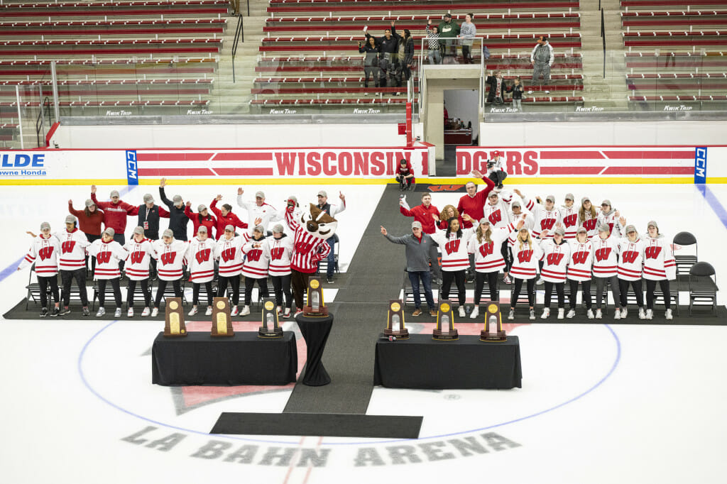 Members of the team and coaching staff sing Varsity during the celebration.