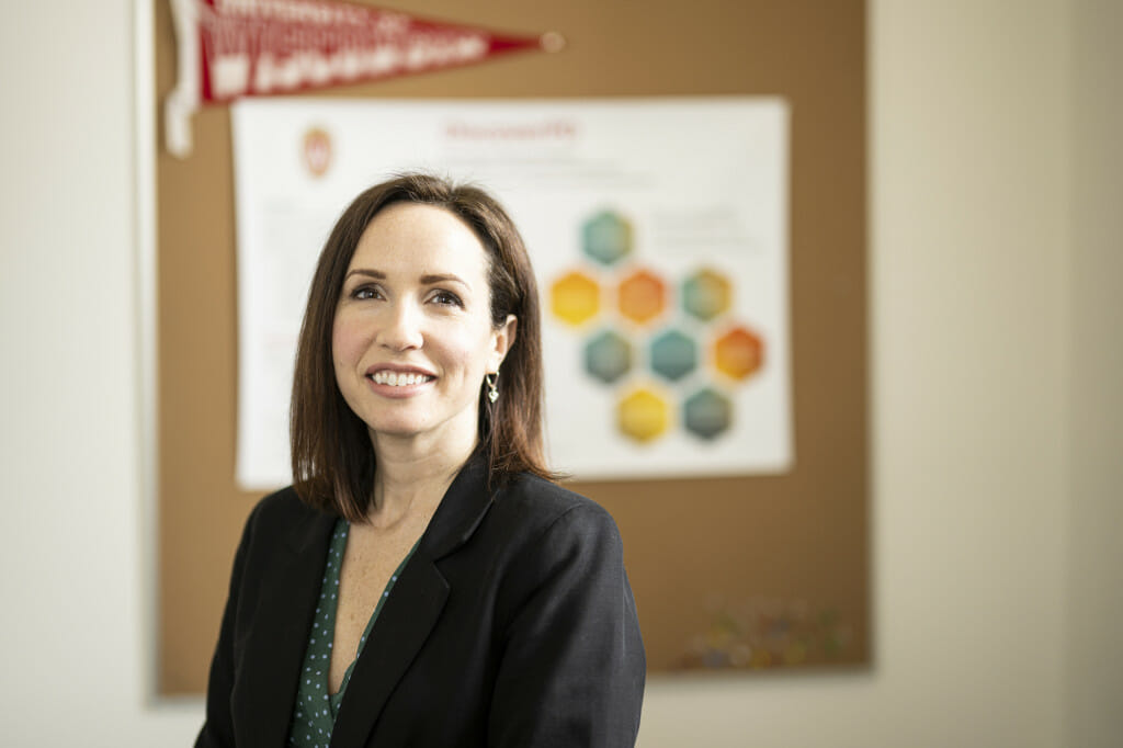 A woman sits at a desk in an office.