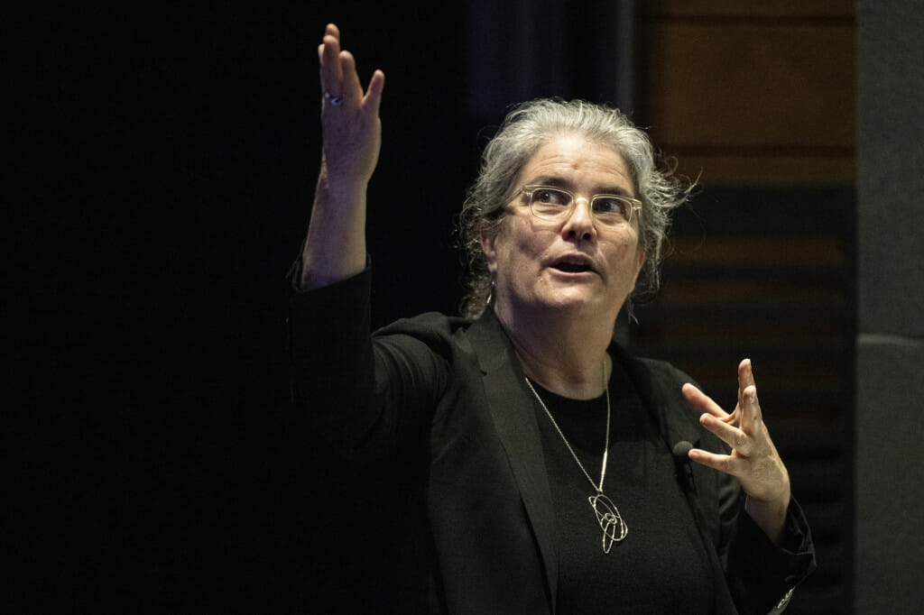 A woman gesticulates as she talks.