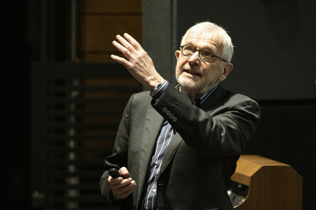 A man gesticulates as he talks.