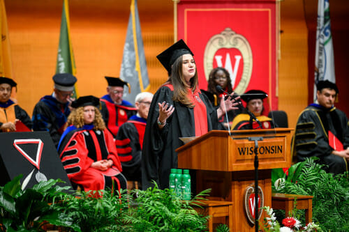 A woman speaks at a lectern.