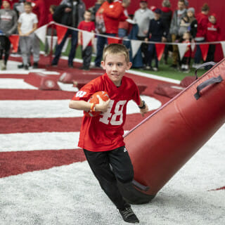 A child runs by a blocking dummy.