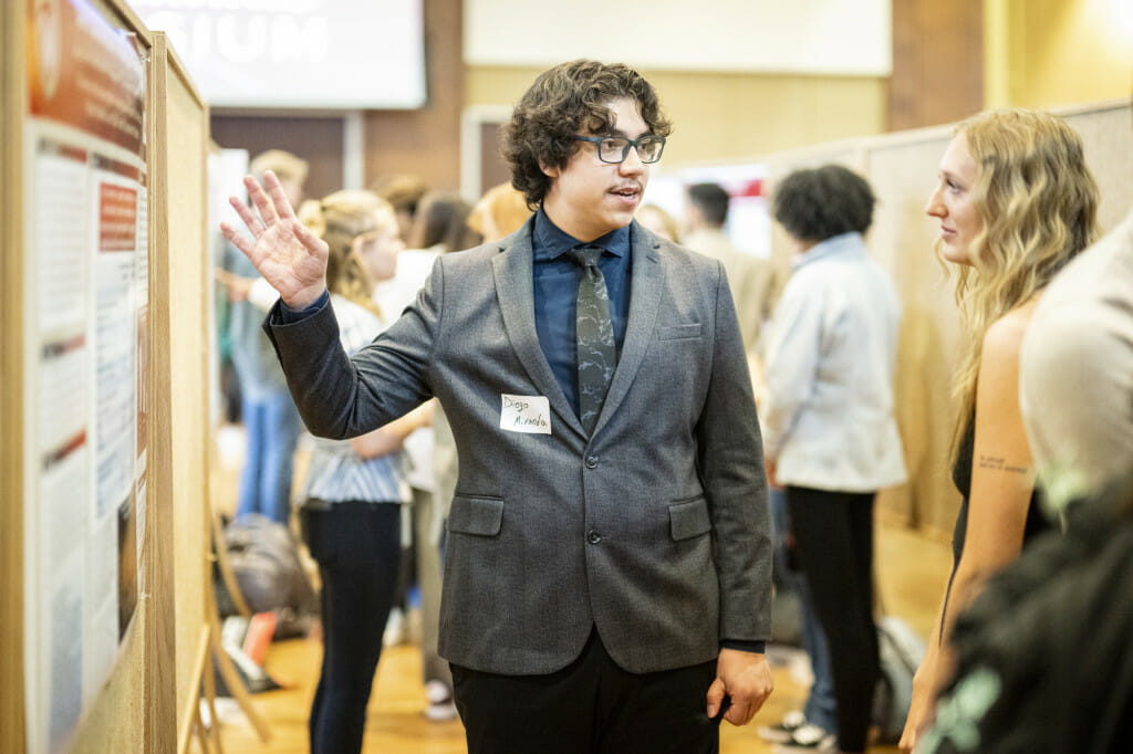 A man gestures while talking.