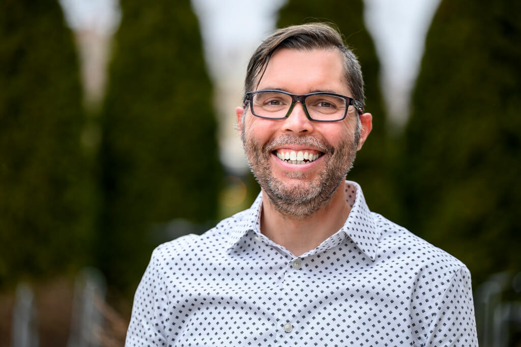 A man smiles at the camera.