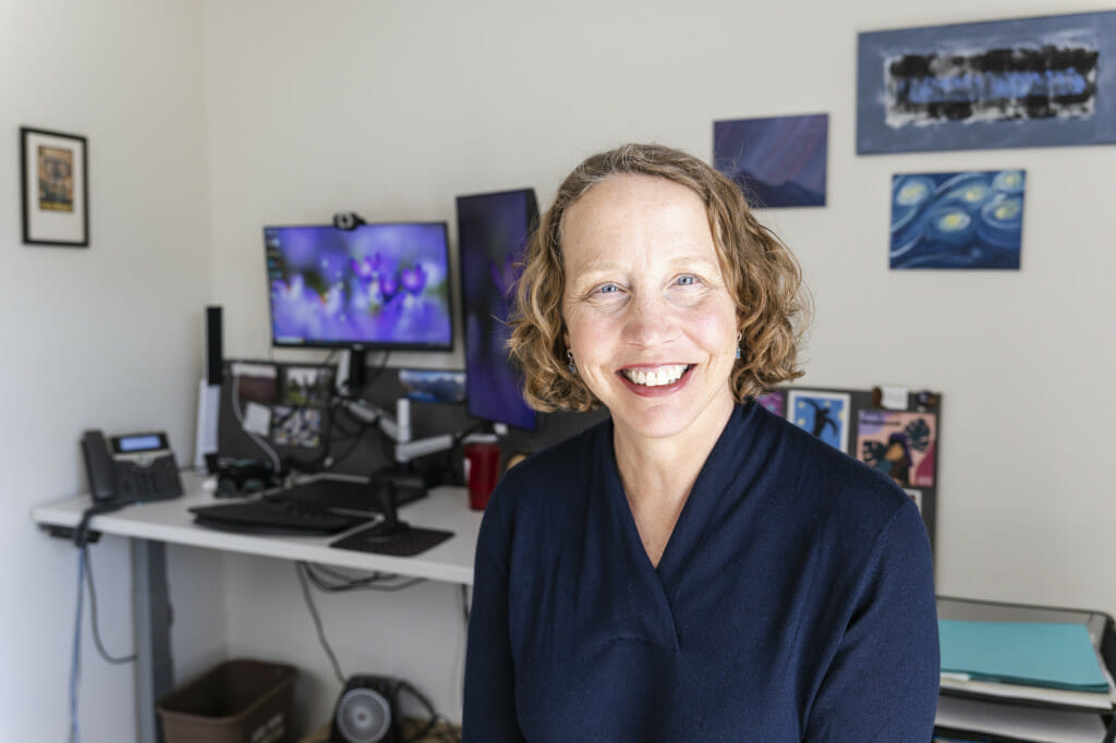 A woman sits in an office.