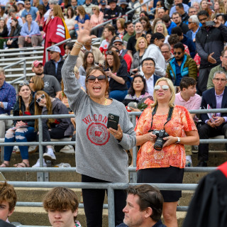 Two people in the stands cheer.