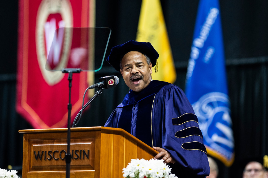 A man speaks at a podium.