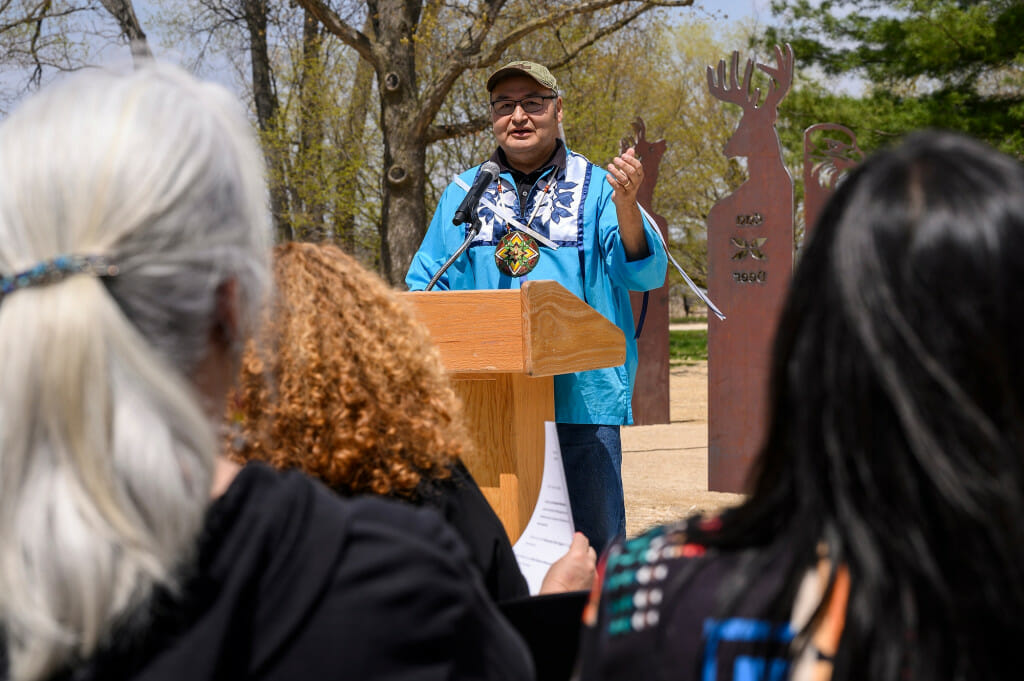 Photo: A man speaks at the podium.