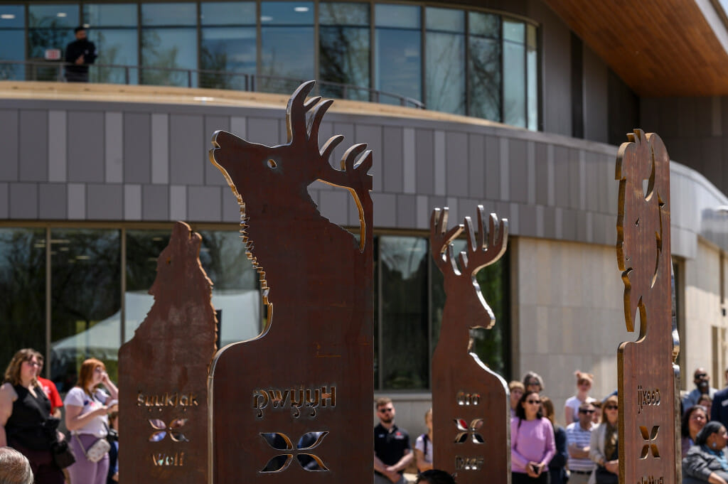 Relief sculptures depicting animals are show in silhouette.