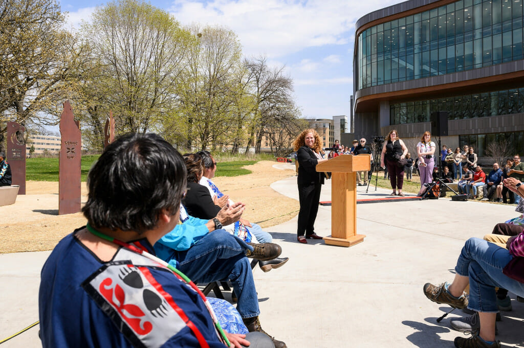 Photo: A woman speaks at a podium.